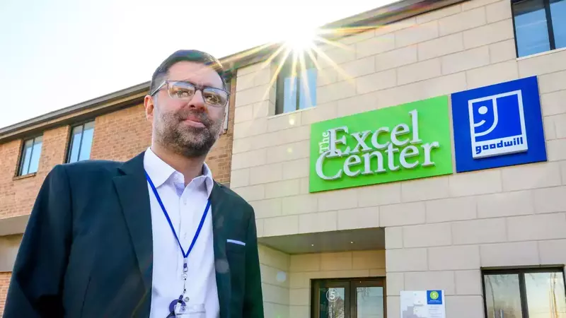 Man standing in front of a Goodwill Excel Center storefront