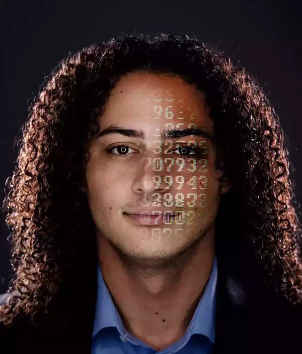 A headshot of Austin Wyman with numbers projected on his face.