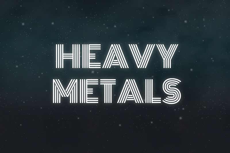 The words ‘HEAVY METALS’ in a striped, neon font against a dark, starry background. 