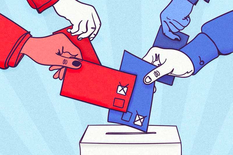 Multiple hands, some wearing red sleeves and others blue, drop red and blue ballots with checkmarks into a ballot box.