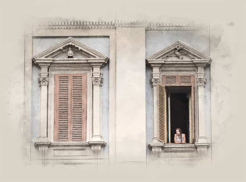 A girl leans out of a large ornamental window in a building next to Piazza Navona in Rome, Italy.