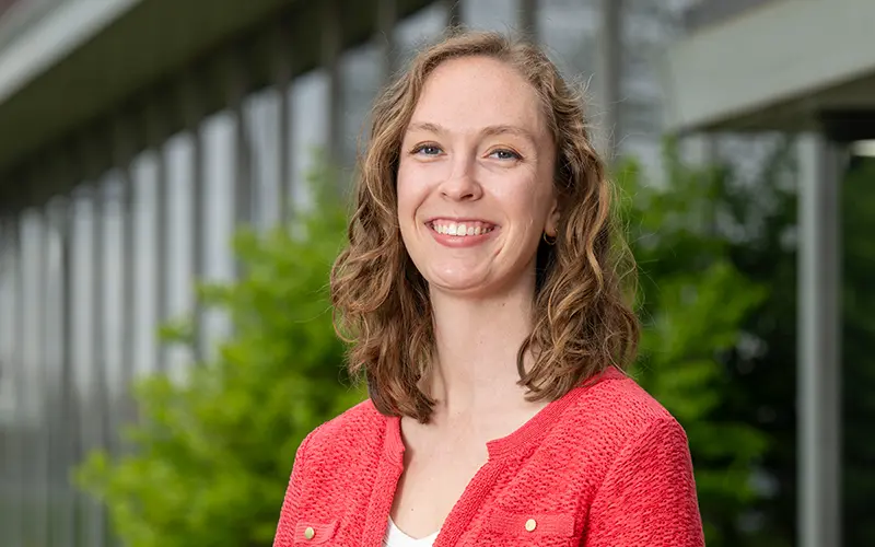 A portrait of Katie Edler in front of trees.