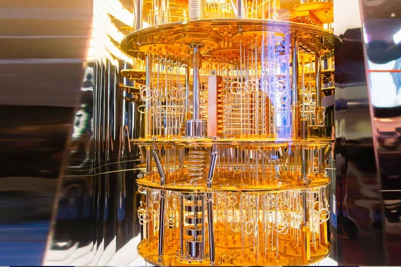 A complex, multi-tiered quantum computer dilution refrigerator, gleaming in gold and silver, with intricate wiring, vertical rods, and a soft blue glow emanating from within.